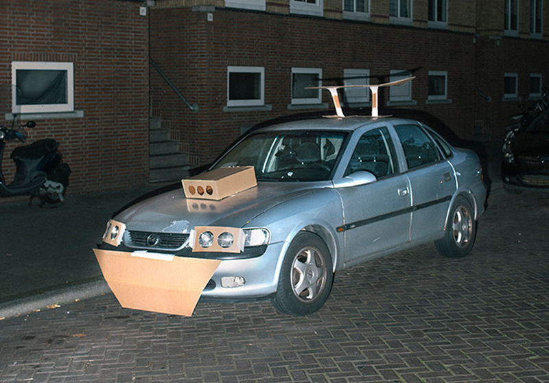 Illustration for article titled This Artist Turns Boring Rides Into Supercars At Night Using Cardboard